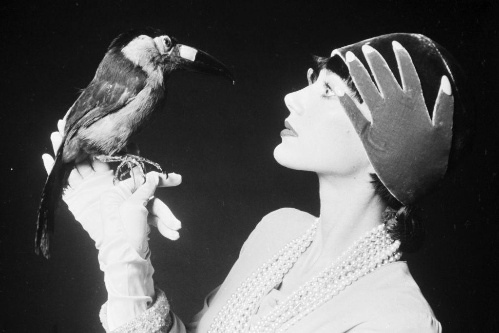 Marisa Berenson wearing Tan Giudicelli hat, Marisa wearing faux pearl necklace.