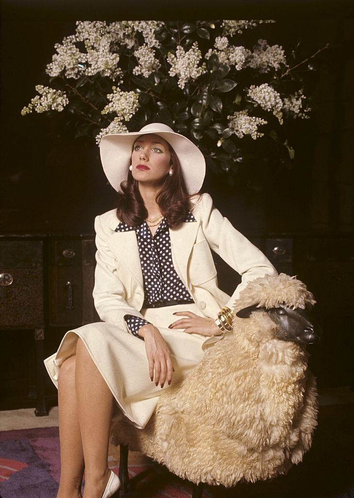 Marisa Berenson wears a white gabardine suit over a polka-dot silk blouse, 1972.