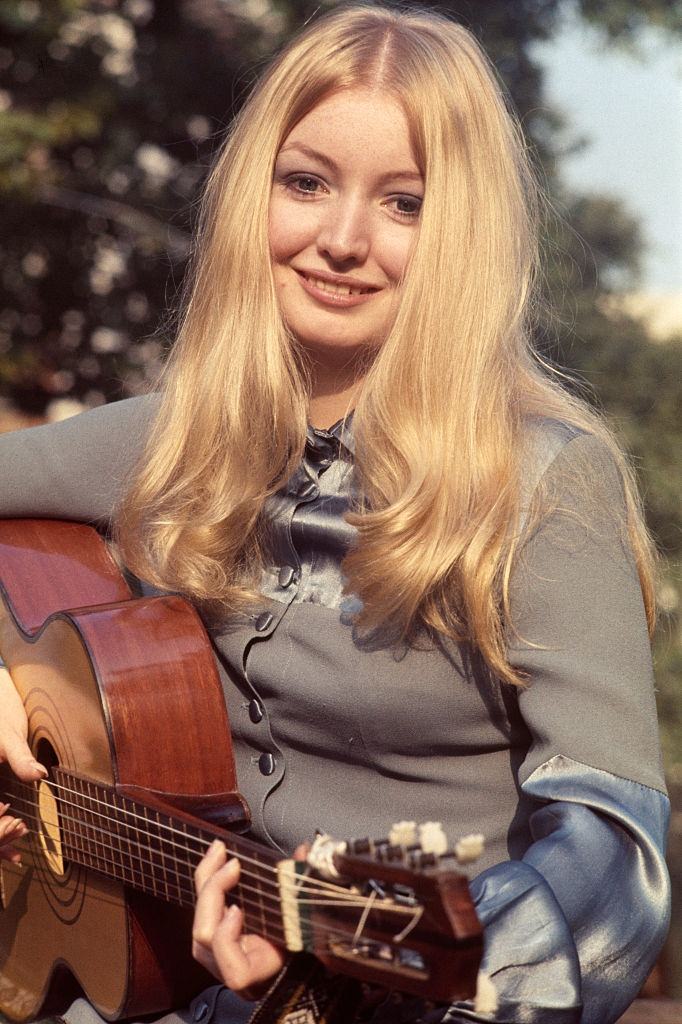 Mary Hopkin posed holding an acoustic guitar in London in October 1969