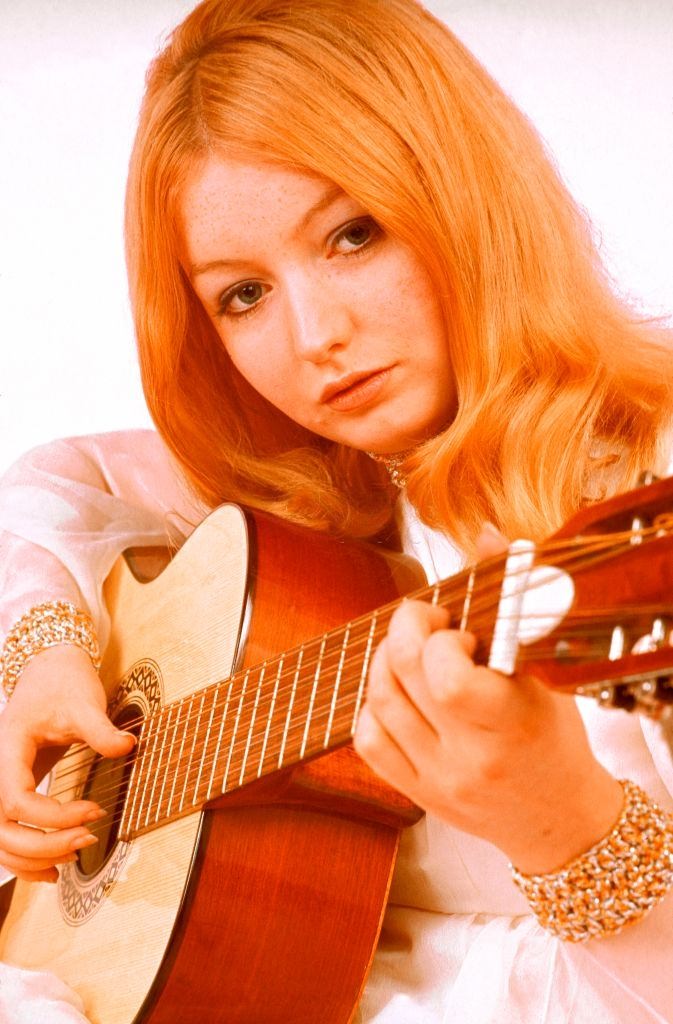 Mary Hopkin playing an acoustic guitar, 1960s.