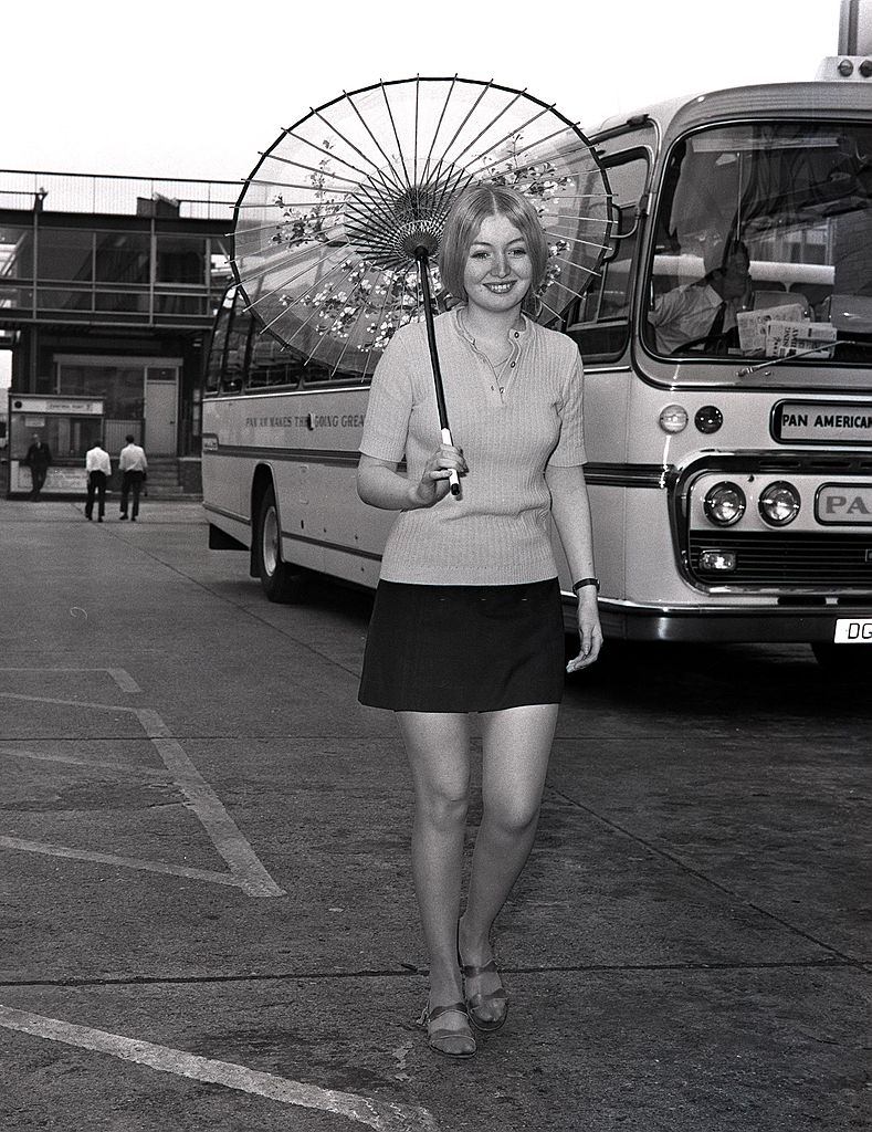 Mary Hopkin holding an oriental parasol after arriving at Heathrow airport from Osaka, Japan where she sang on television, 1970.