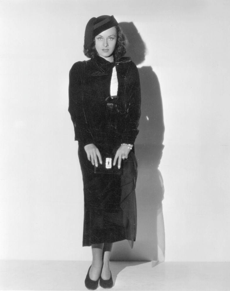 Paulette Goddard posing in a black dress, 1935.