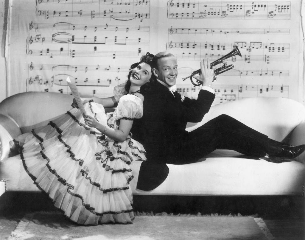 Paulette Goddard with Fred Astaire sitting on the sofa, 1940.