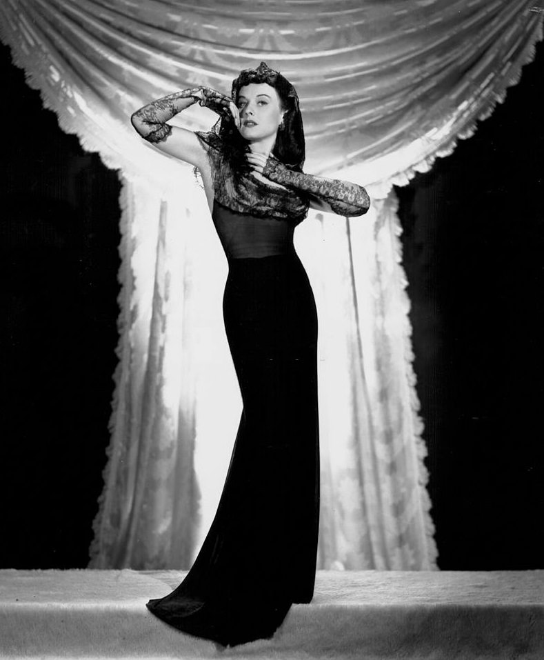 Paulette Goddard wearing a black evening gown, for Paramount Pictures, 1940.