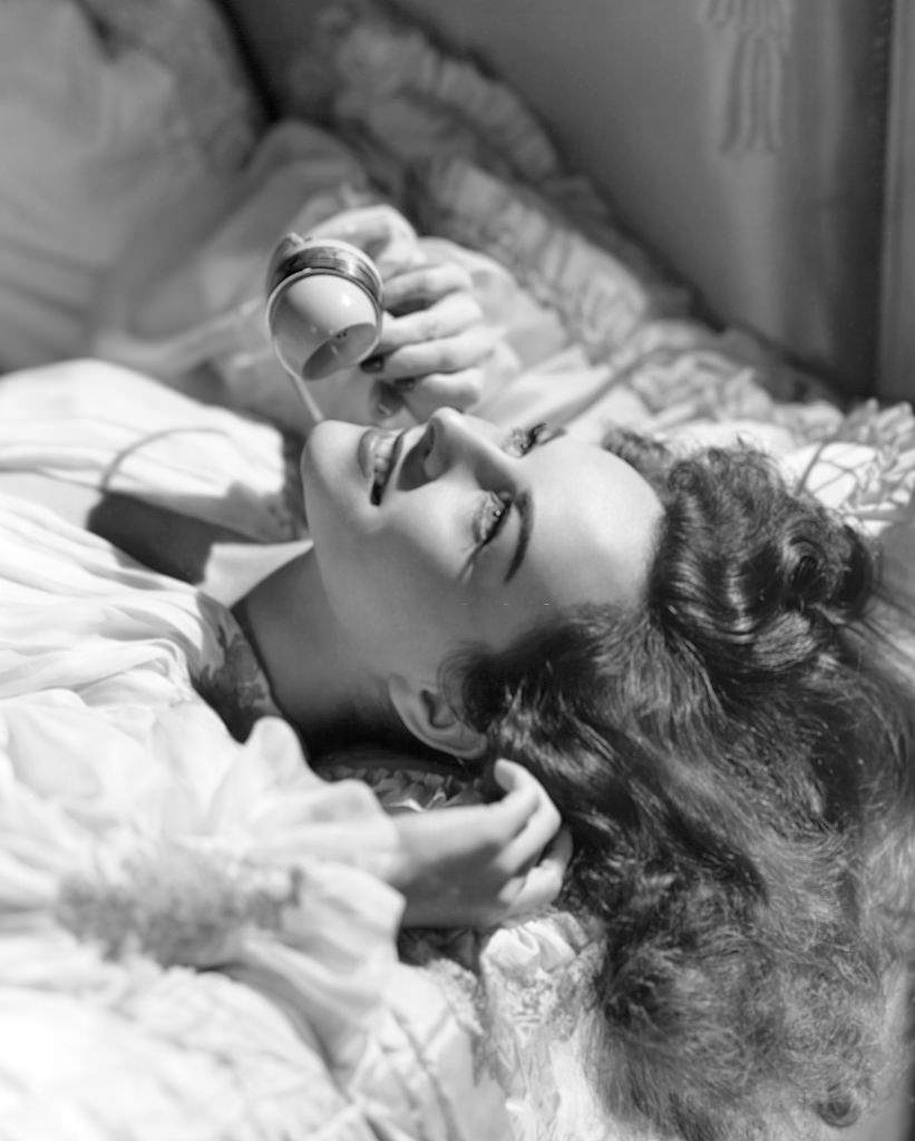 Paulette Goddard on Bed with Telephone, 1940.