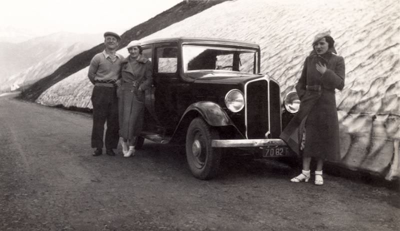 Three members of a middle-class family posing with a Renault Monaquatre on a mountain road, Col du Lautaret in the French Alps, 1936