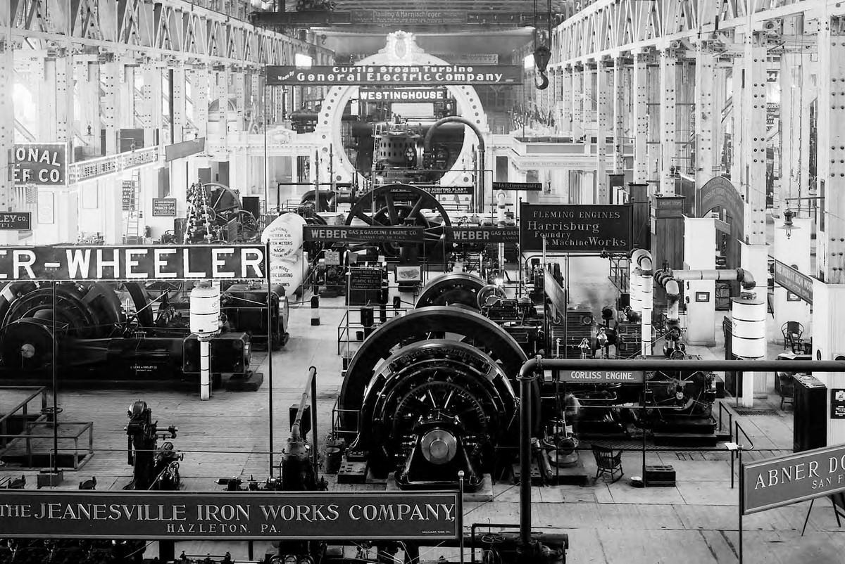 A view of the Allis-Chalmers exhibit in the Palace of Machinery shows exhibits from companies such as Jeanesville Iron Works, Crocker-Wheeler, Doble Abner, Harrisburg Foundry, General Electric, and Westinghouse.