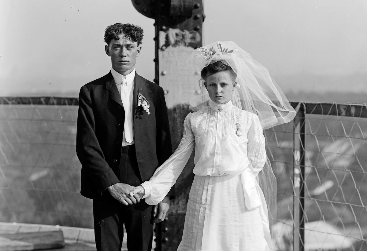 A bride and groom pose for their wedding photograph at the top of the DeForest Wireless Telegraph Tower at the Louisiana Purchase Exposition.