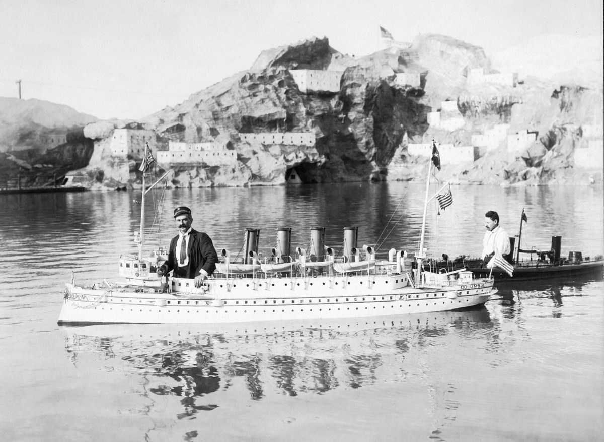 Two model American warships and operators, photographed at the Naval Show at the Pike