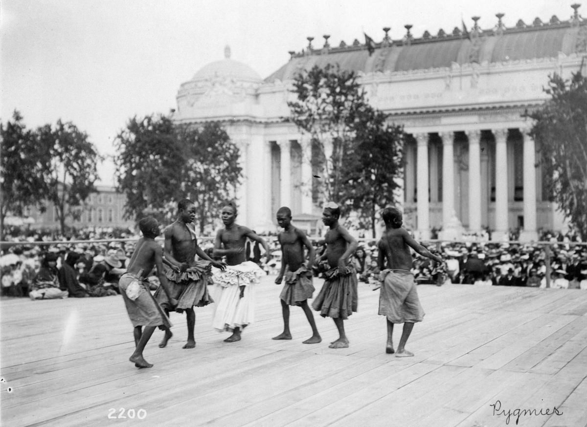 Pygmies from Central Africa dancing on platform in front of the Palace of Manufactures at the 1904 World's Fair on 28 July 1904