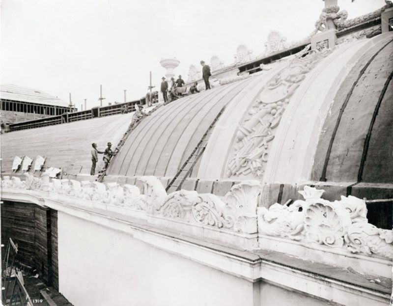 Workers preparing the roof of the Palace of Liberal Arts for placement of staff during construction for the 1904 World's Fair, 1904