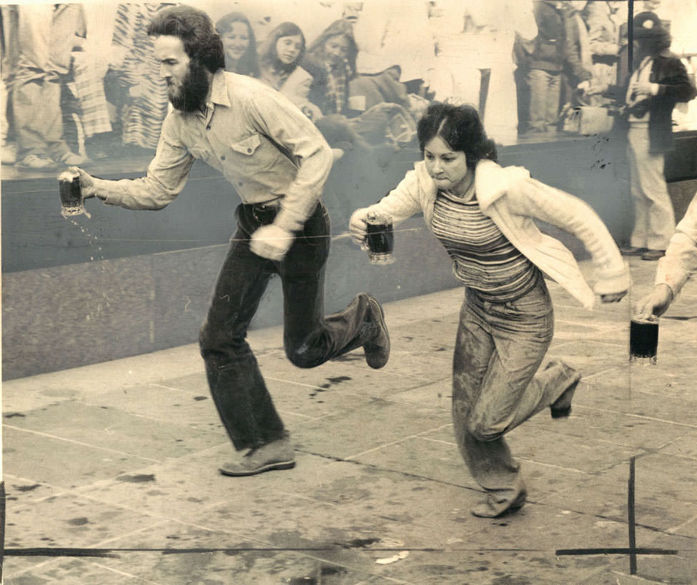 Bernie Keenan (with beard) defeats Casey Cole in Hopkins Plaza on the way to victory in St. Patrick’s Day Beer Mug Race. March, 1979.