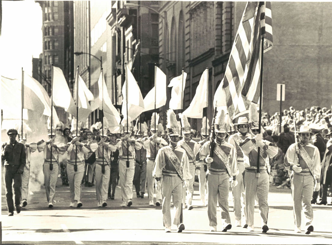 One of the 43 units that took part in yesterday’s St. Patrick’s Day parade in a chilly breeze steps out briskly at Baltimore and Calvert streets. March 1976.