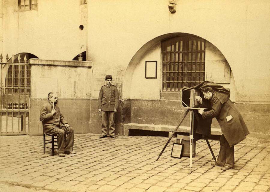 Photographing a suspect in the courtyard of the Prefecture of Police in Paris.