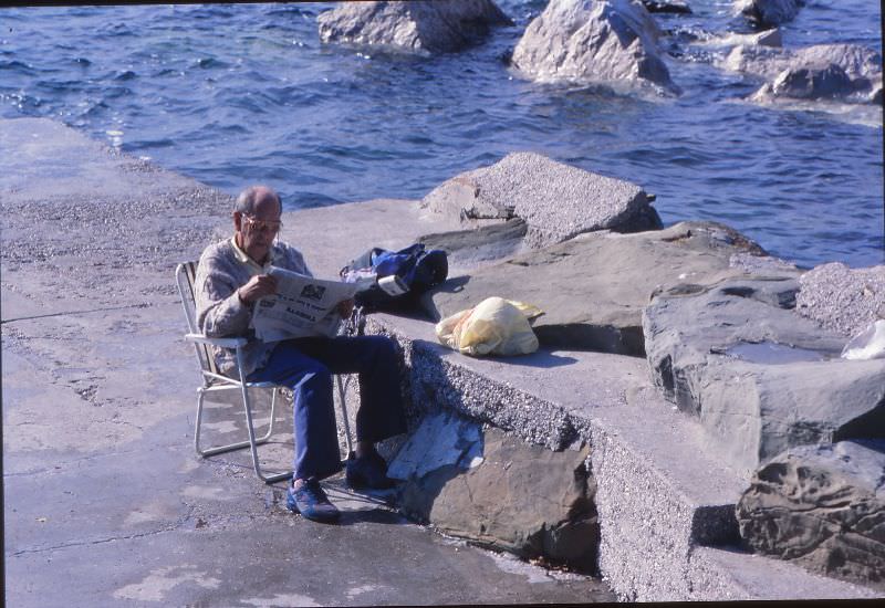 Old man reading newspaper