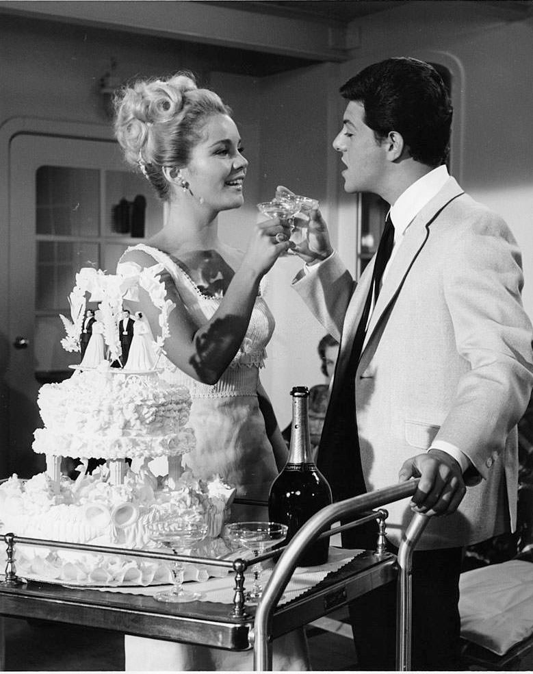 Tuesday Weld and Frankie Avalon toast each other at wedding ceremony pointing at unidentified man in a scene from the film 'I'll Take Sweden', 1965.