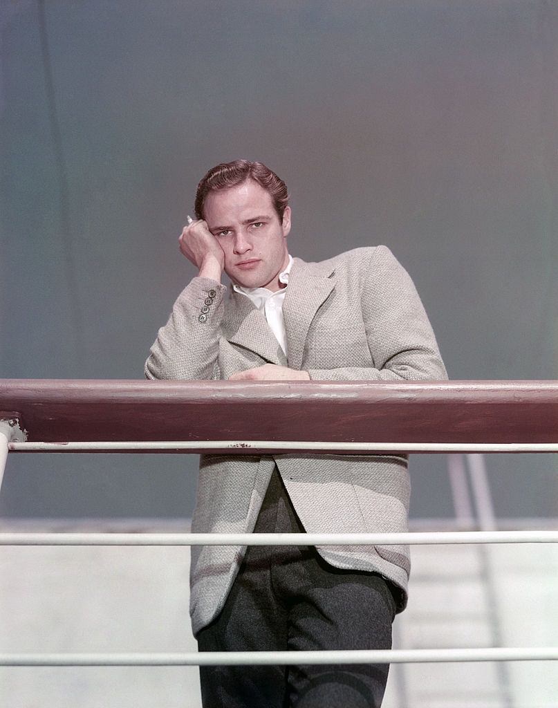 Marlon Brando leaning on the parapet of a boat and posing, 1945.