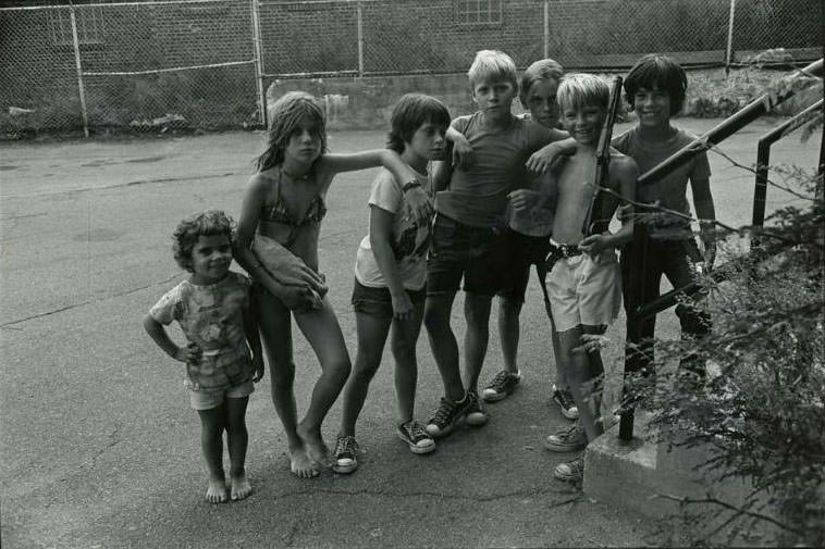 Seven children standing in the courtyard of the Jefferson Park Housing Project, Jefferson Park, 1974