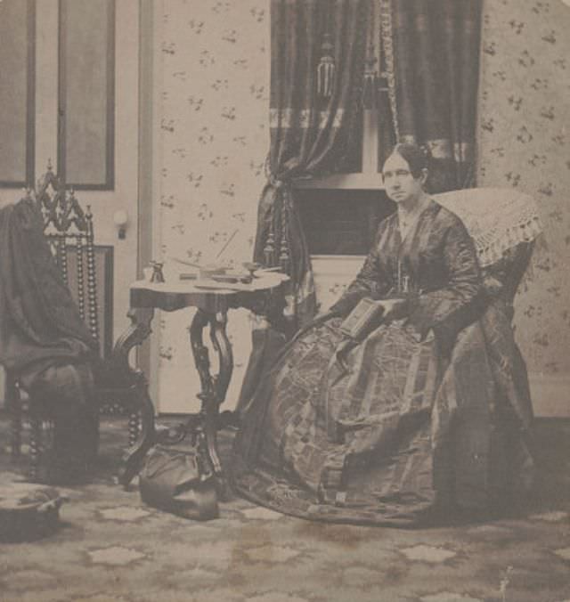 Miss Dorothea L. Dix, Superintendent of Army Nurses for the Union Army, holding a book and sitting in a room with a medical bag on the floor