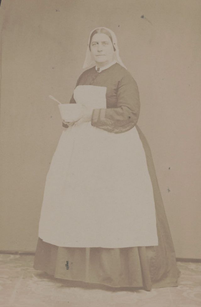 Civil War nurse partially identified as Miss Davis of South Street Hospital, Philadelphia, Pennsylvania, in traditional nurse's uniform