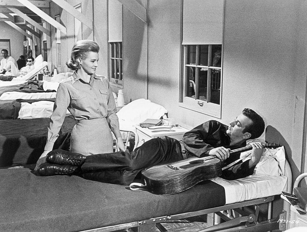 Angie Dickinson introduces herself to a new patient, Bobby Darin. A scene from Universal's "Captain Newman, M.D.