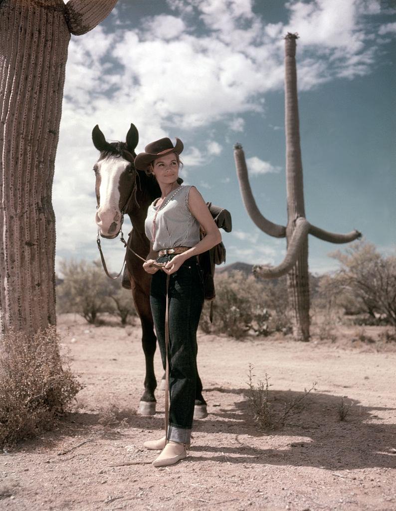 Angie Dickinson with a horse, 1959.