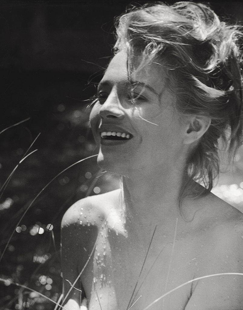 Angie Dickinson posing laughing after swimming. 1961