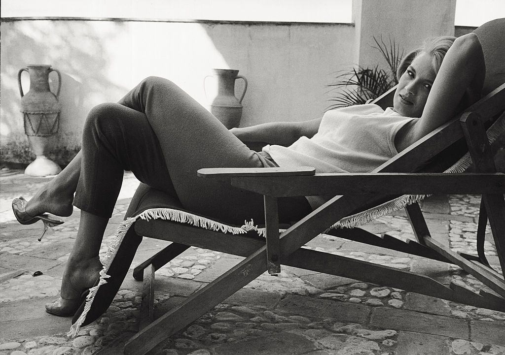 Angie Dickinson sitting on a deckchair on a terrace, 1961.