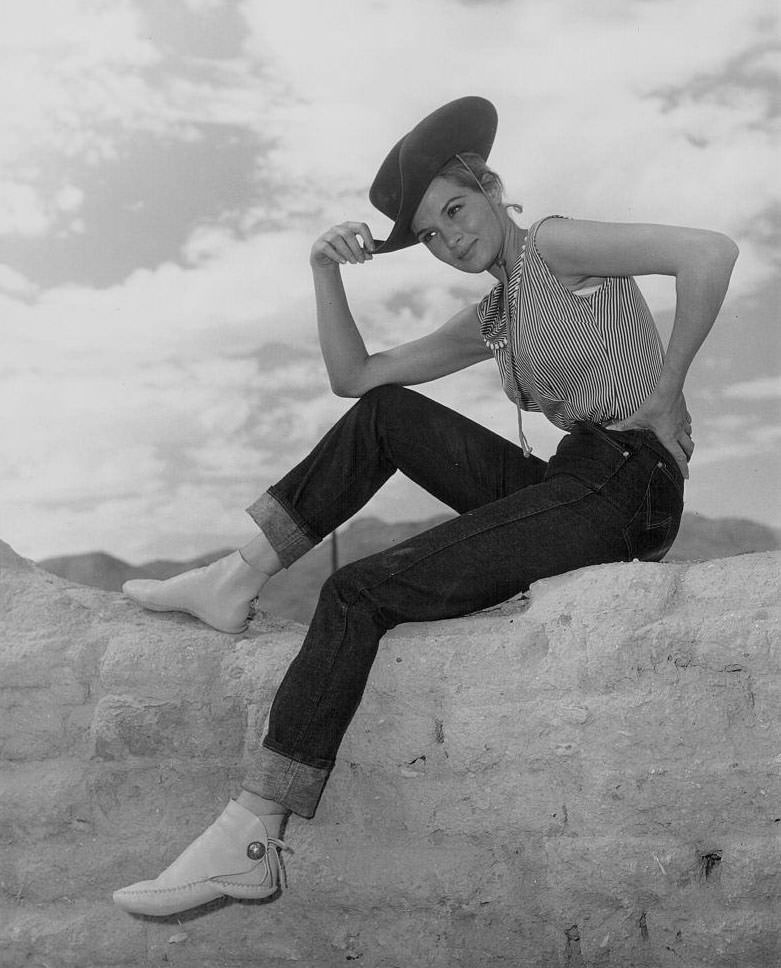 Angie Dickinson, wearing a high necked blouse and earrings, 1955.