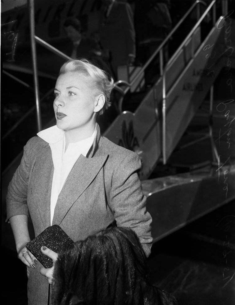 Barbara Payton waiting at the airport, 1951.