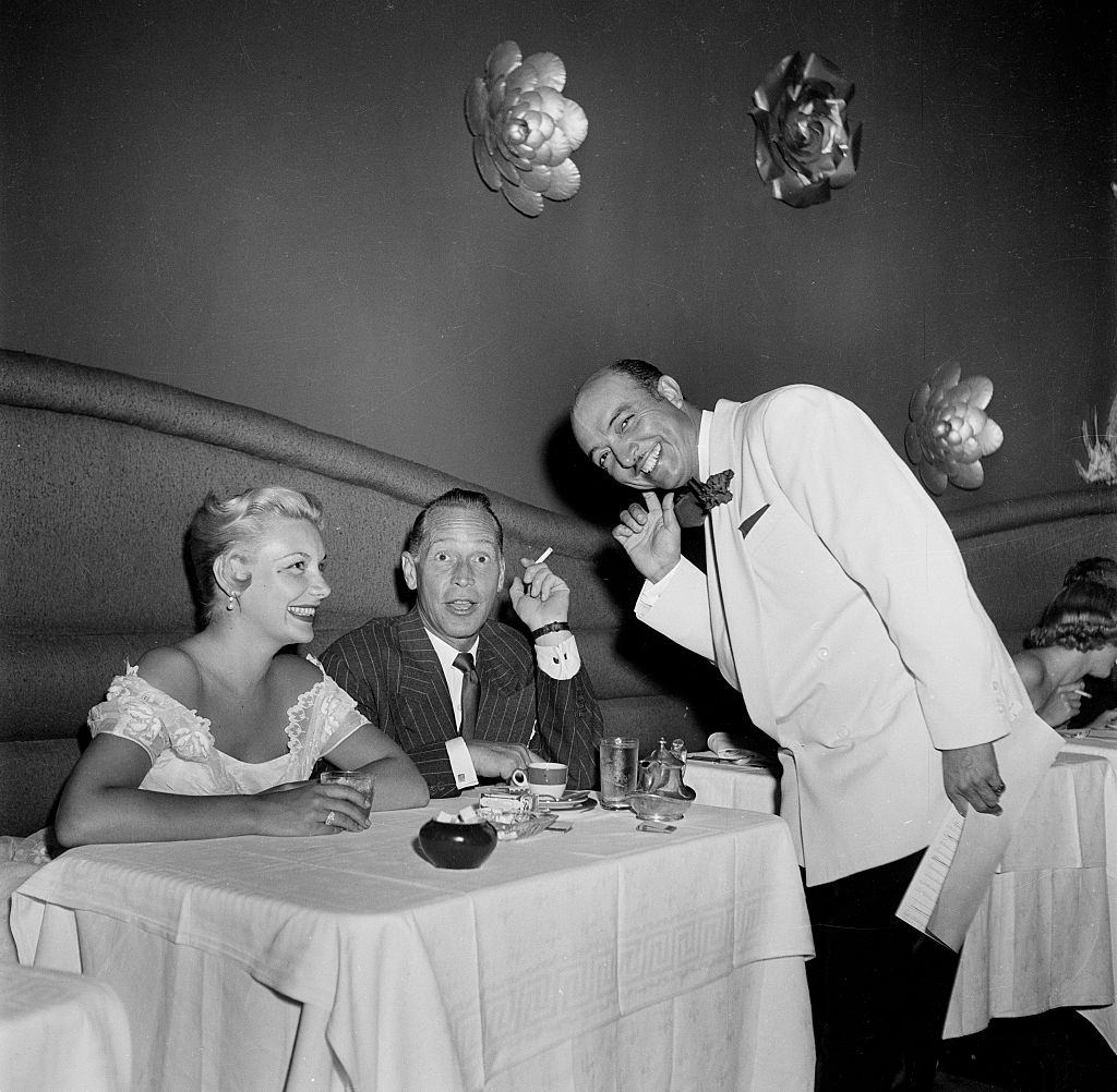 Barbara Payton with Franchot Tone at Mocambo's in Los Angeles, 1951.