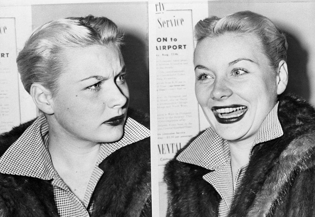 Barbara Payton frowns then laughs as she is interviewed upon her arrival at airport, 1951.