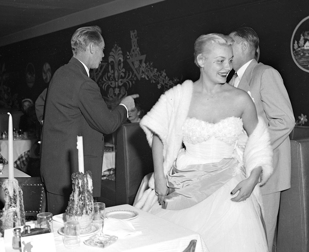 Barbara Payton, leave table in Little Gypsy restaurant, 1951.