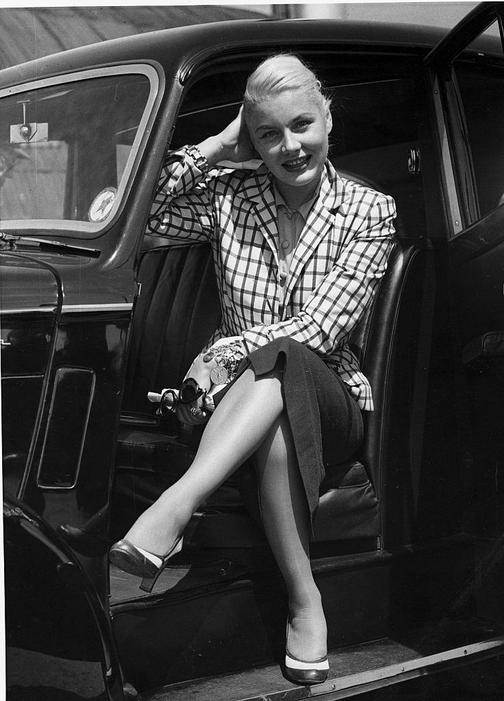 Barbara Payton sitting in the car, 1952.