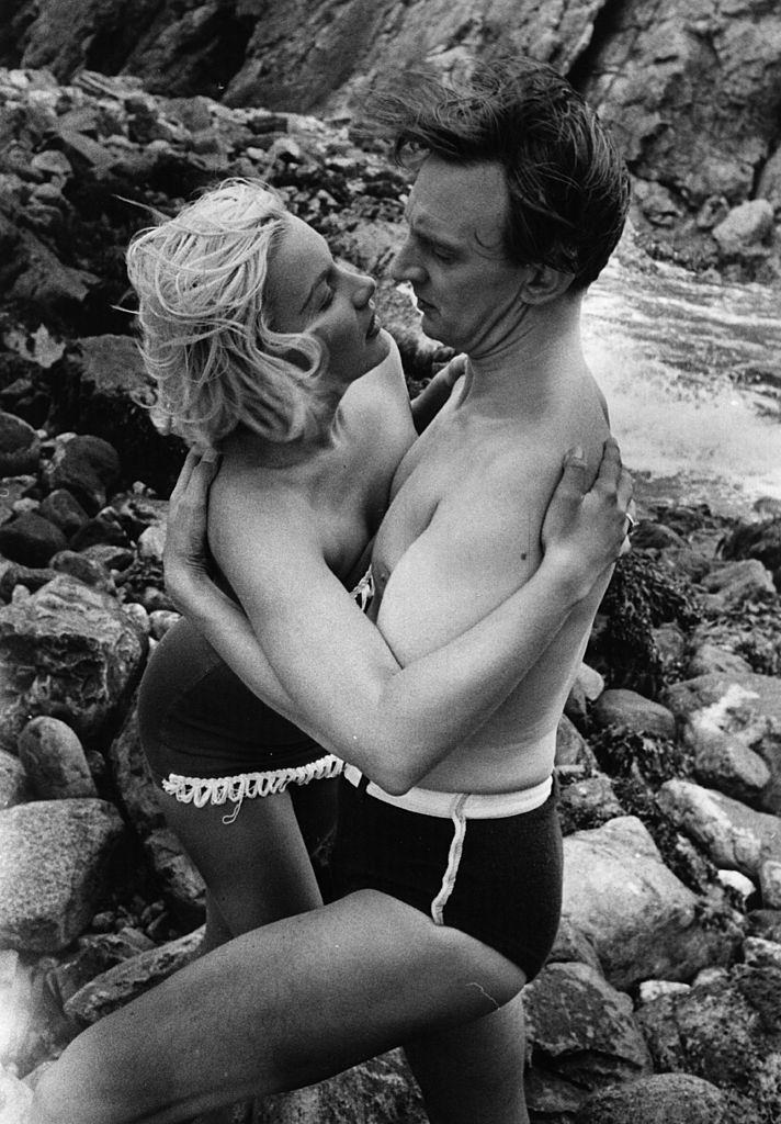 Barbara Payton with Stephen Murray on the beach during the filming of 'The Four Sided Triangle' , 1952.