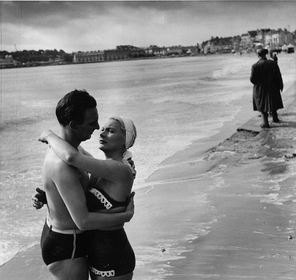 Barbara Payton with Stephen Murray for a scene in a British film, 'The Four Sided Triangle' being shot at Weymouth in Dorset, 1952.