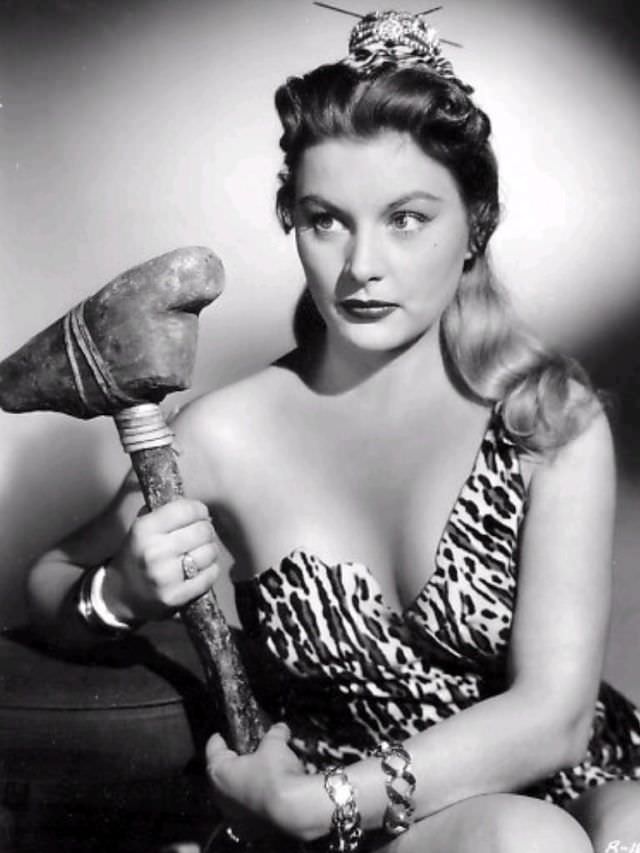 Barbara Payton holding a hammer, 1950.