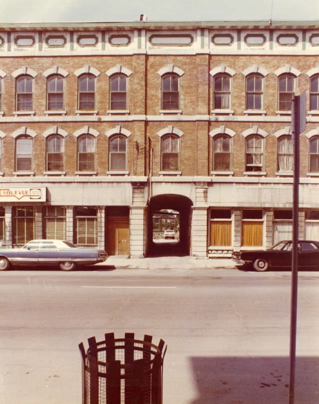 160, 162 and 166 Front Street, Belleville, Ontario. The Corbin Lock building on Coleman Street is visible through the passage way