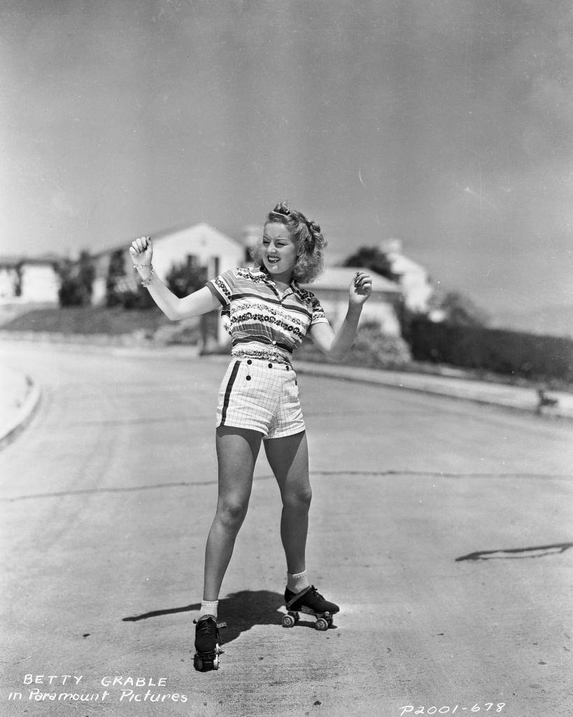 Betty Grable balancing on a pair of roller skates, 1935.