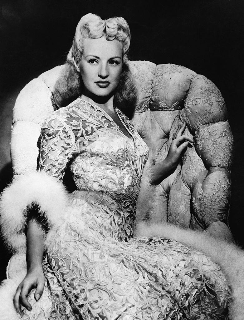 Betty Grable posing on the sofa, 1944.