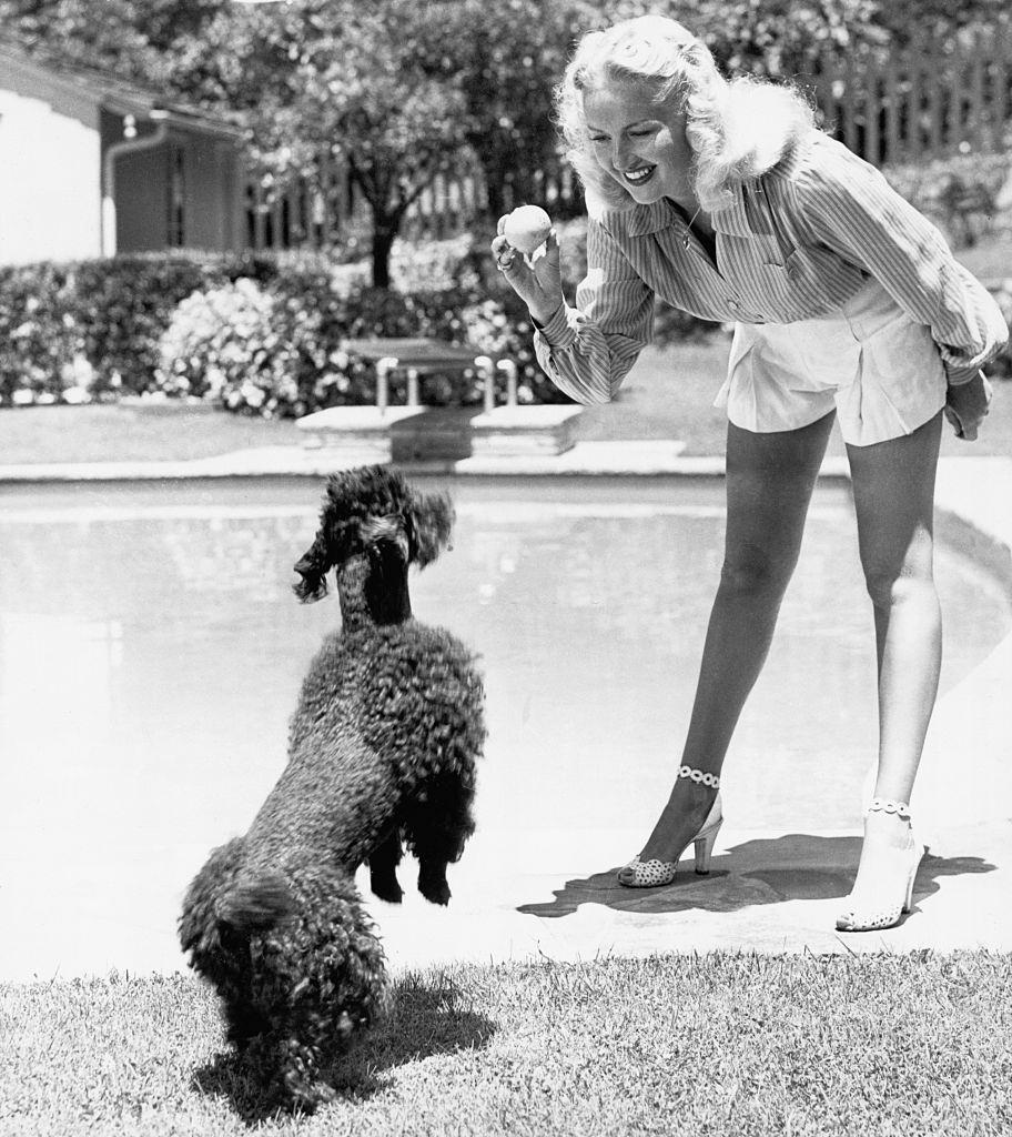 Betty Grable Playing with her Poodle, 1944.