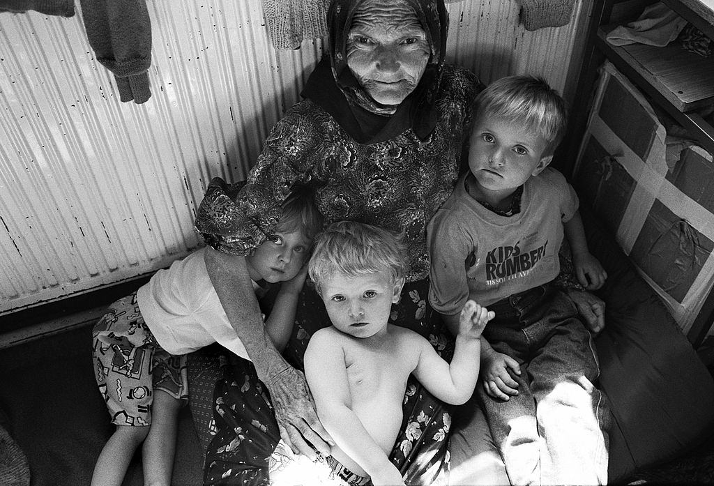 A Muslim grandmother hugs her young grandchildren at a refugee centre set up near Tuzla for people fleeing the Srebrenica massacre.