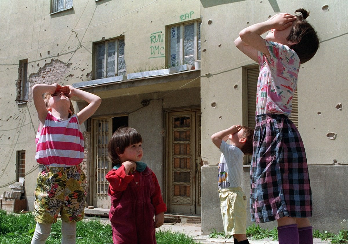 Children look up at fighter jets enforcing the no-fly-zone over Sarajevo, Bosnia Herzegovina, on May 12, 1993.