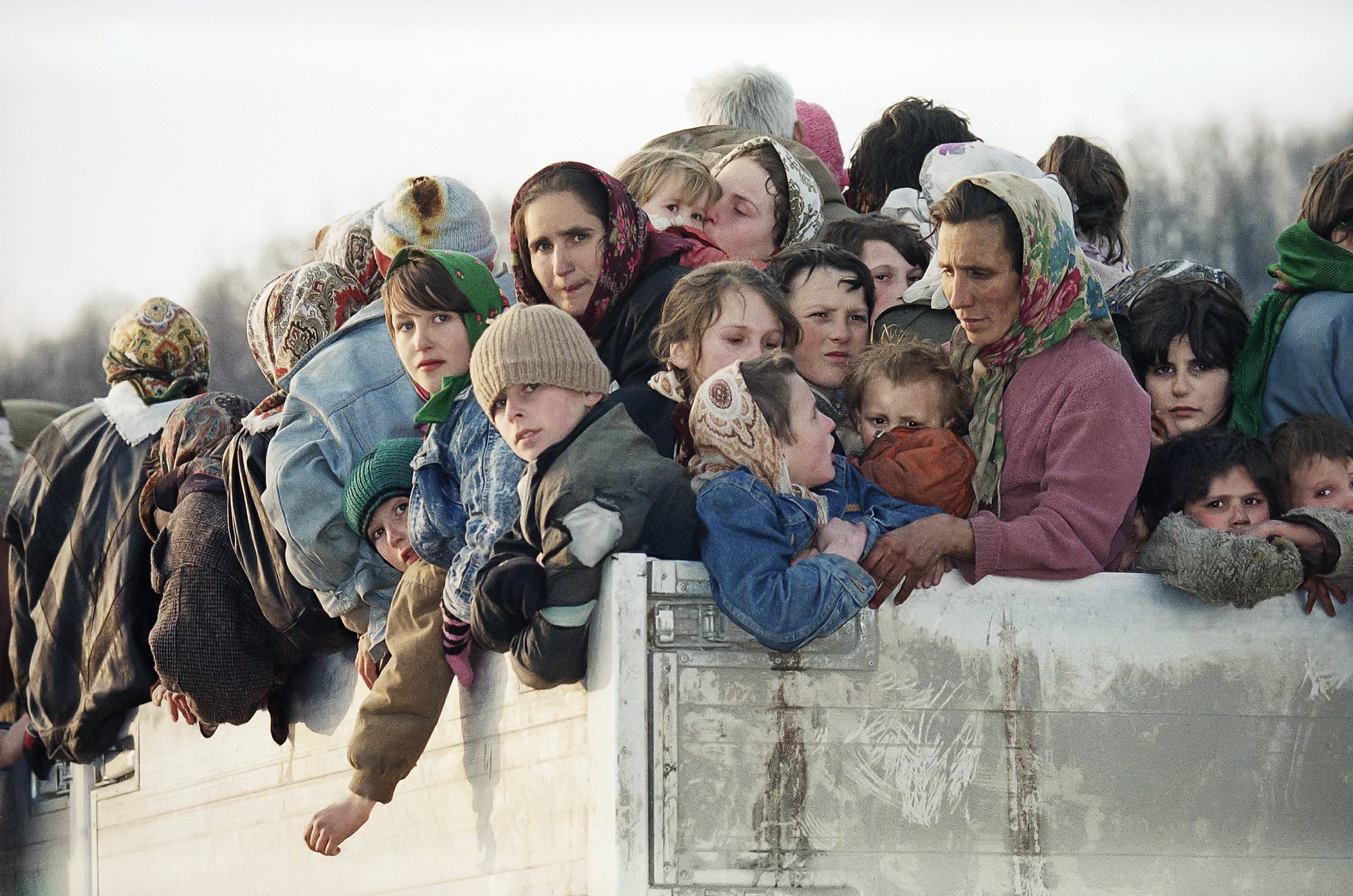 Evacuees from the besieged Muslim enclave of Srebrenica, packed on a truck en route to Tuzla, pass through Tojsici, March 29, 1993.