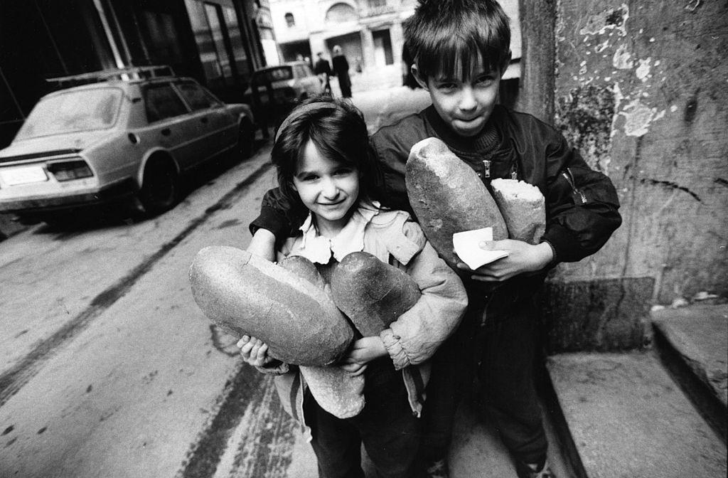 Young children buying bread in Sarajevo, 1994.