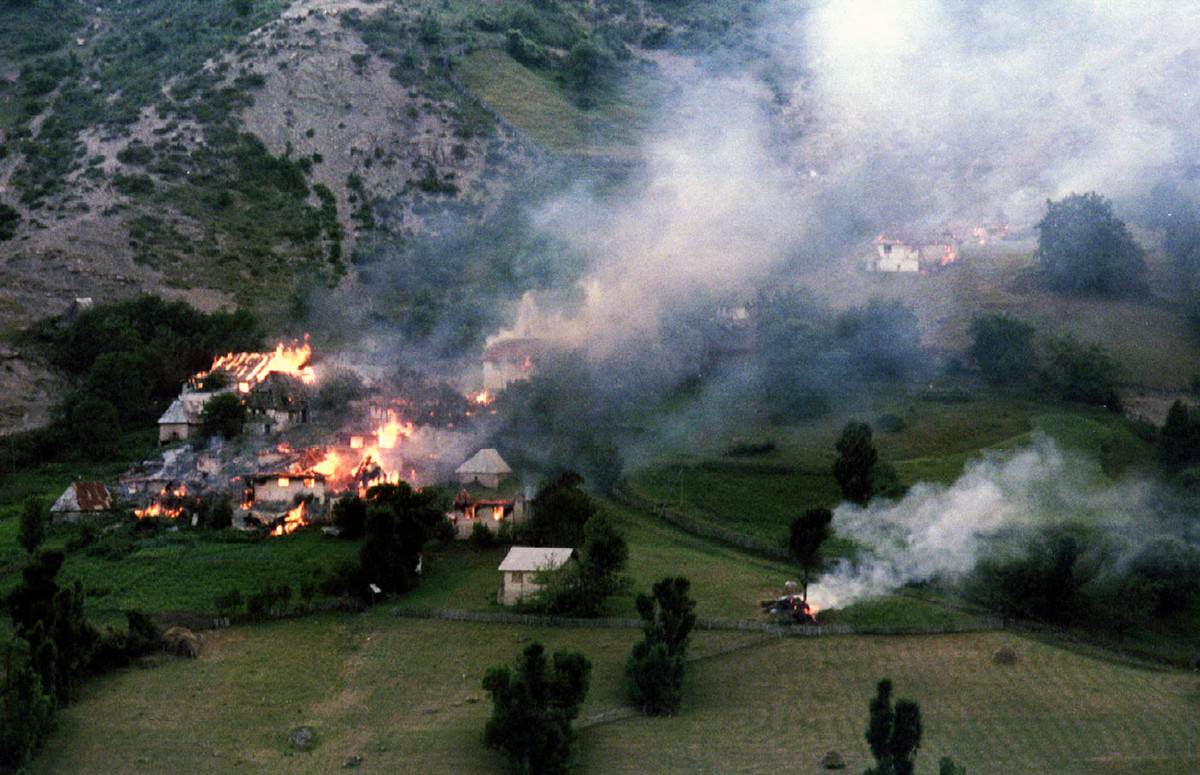 Smoke and flames rise from houses set on fire by heavy fighting between Bosnian Serbs and Muslims in the village of Ljuta on Mount Igman some 40km southwest from the besieged Bosnian capital of Sarajevo, on July 22, 1993.