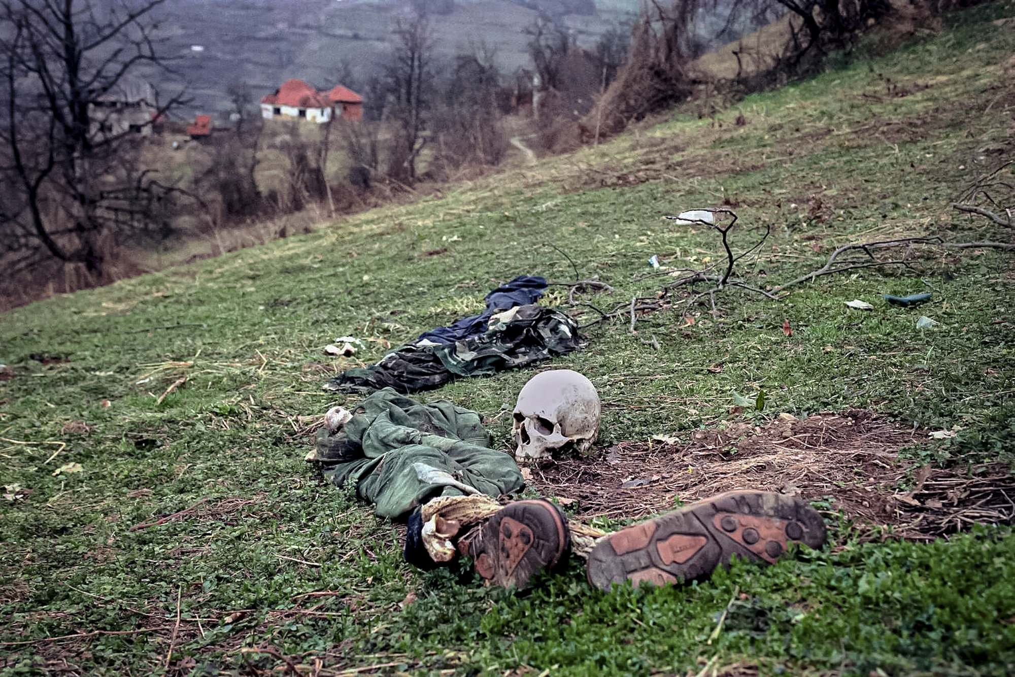 The remains of two bodies and pieces of clothing lie in a field at a suspected mass grave site in the village of Konjevic Polje, approximately 20km (12 miles), north west of Srebrenica, April 2, 1996.