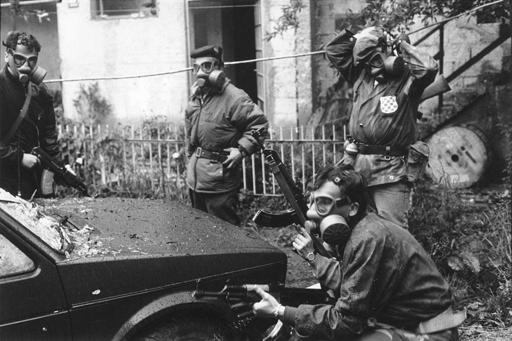 Gas masked soldiers of the Bosnian Army in action on the front-line at Dolniya, Sarajevo, during the war in Bosnia.