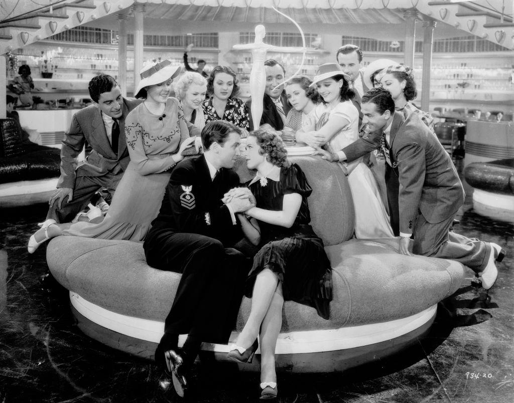 Eleanor Powell and James Stewart attract a nosy crowd in a scene from the musical 'Born To Dance', 1936.