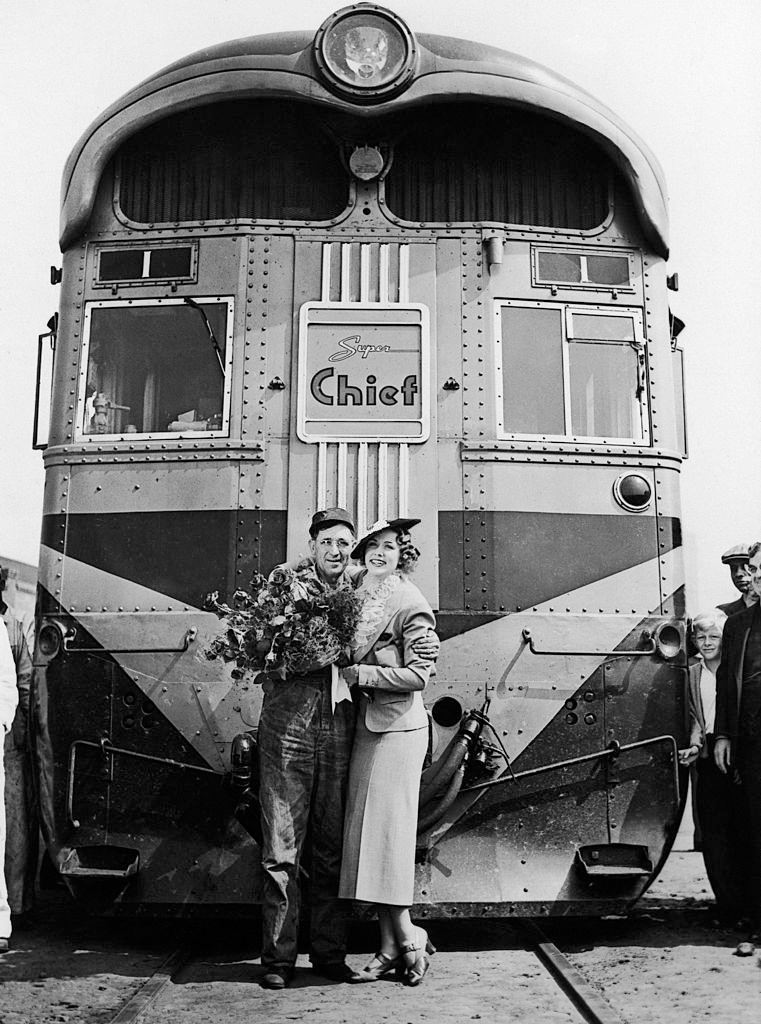 Eleanor Powell arrives in Los Angeles, California aboard The Express Train Super Chief and posing with the Driver, 1936.